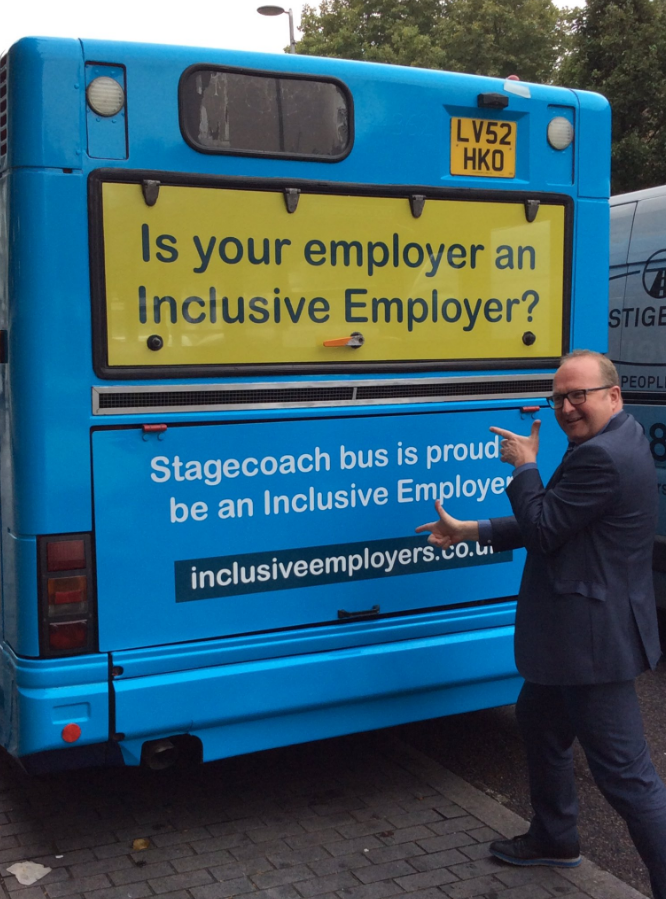 Richard pointing at the Inclusion Week branded bus