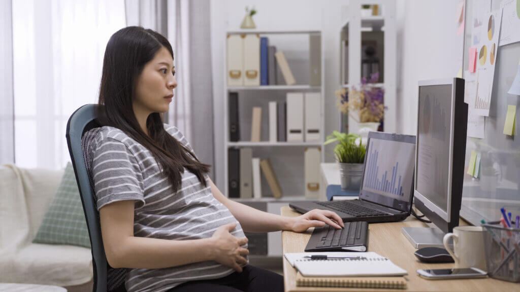 Pregnant woman working at desk