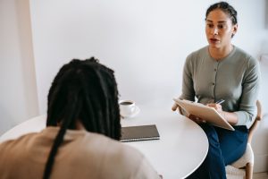 Line manager taking notes during meeting with employee to discuss mental health