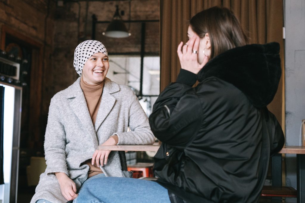 Person with cancer having a chat with a friend