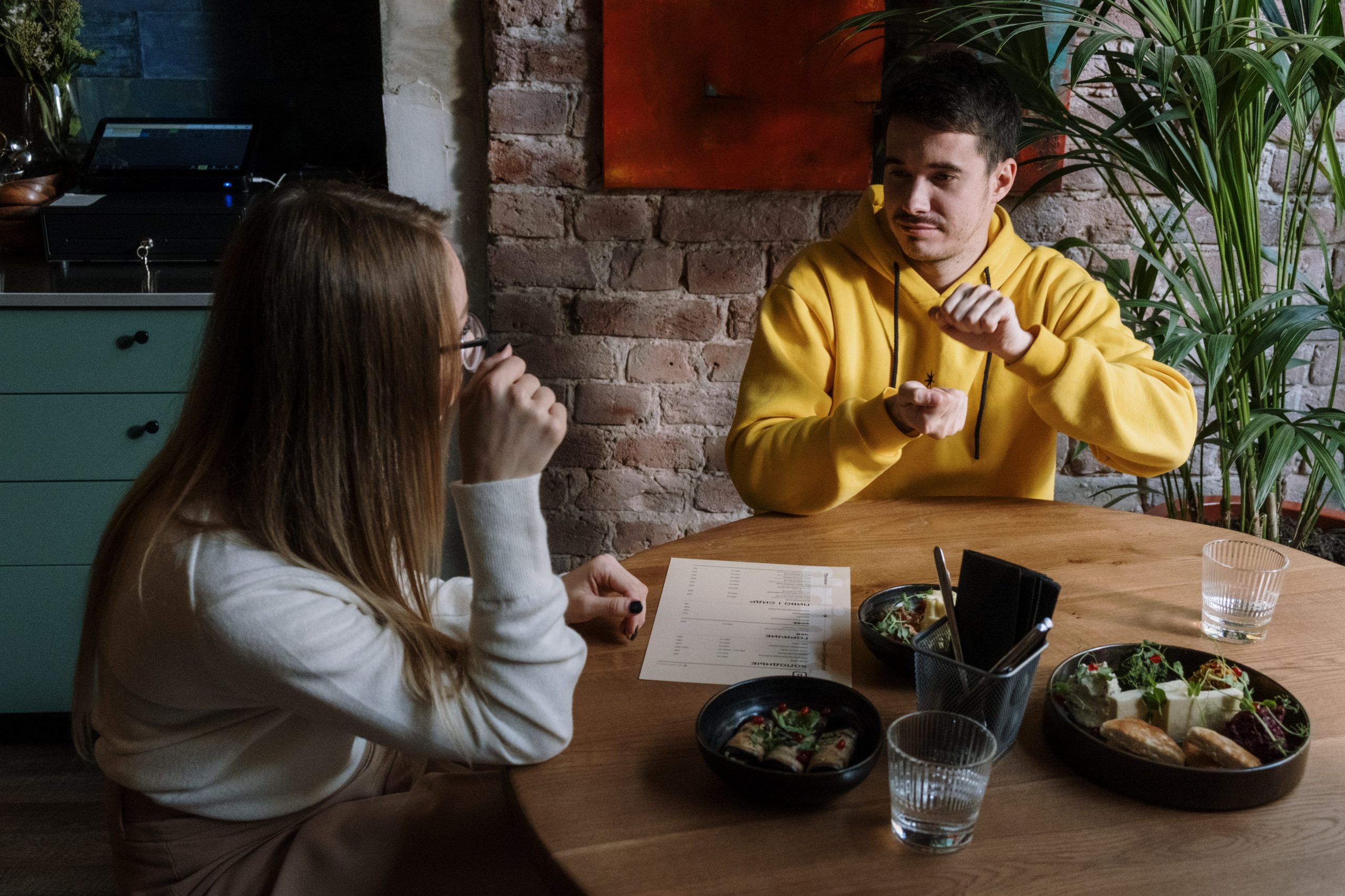 Two people communicating using sign language