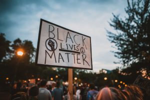 Person holding up black lives matter sign at protest