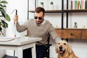 Blind person sitting with their assistance dog