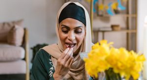 Hijabi woman breaking her fast with a date