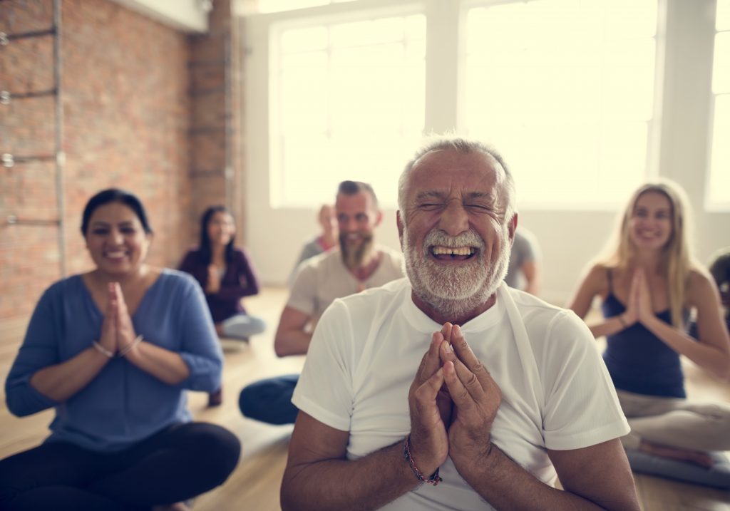 Yoga class full of smiling people