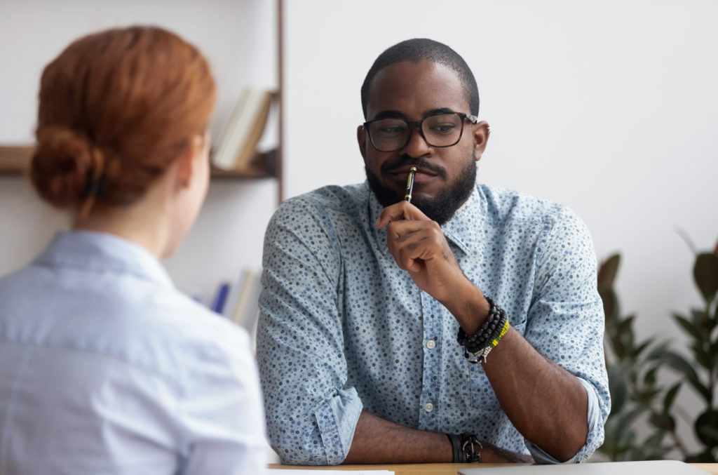 Man pondering what his colleague has told him about inclusion