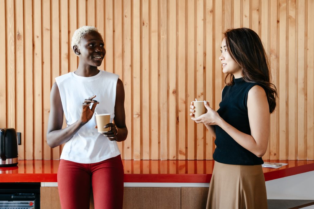 2 colleagues discussing inclusion over coffee