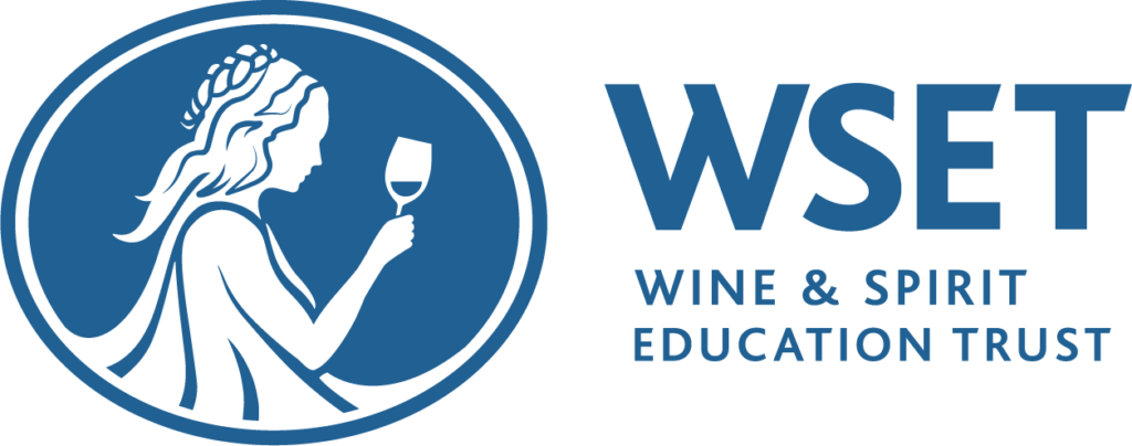 Wine and spirit education trust logo, with a picture of a woman enjoying a sip of wine