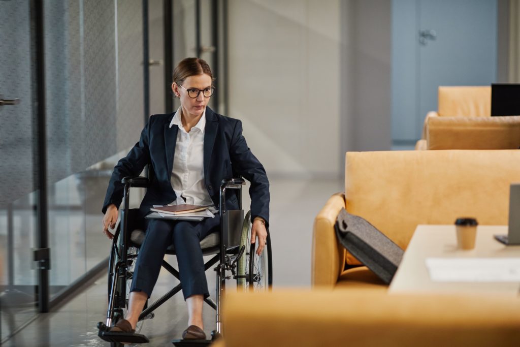 Women in a wheelchair able to navigate her chair through wide spaces in the workplace