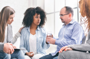 Domestic abuse victim being comforted by her colleagues