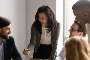 Middle aged Asian woman with menopause leading a meeting at work