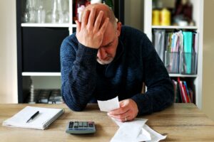 Middle aged man stressed about the cost of living crisis