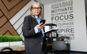 Older Businesswomen reading Inclusive Employers blog on ageism