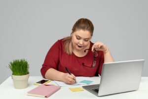 Plus sized female office worker at her desk