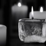 Black backdrop with a row of mourning candles