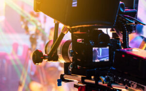 Image of a movie camera on set with a halo of colourful lights