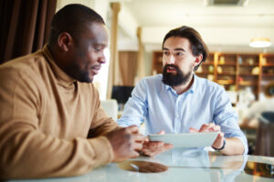 An employee and line manager having a meeting about reasonable adjustments in a quiet office area