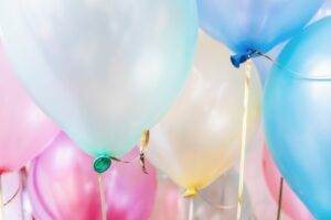A collection of pastel coloured balloons on strings