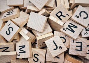 Wooden Scrabble letters in a pile.