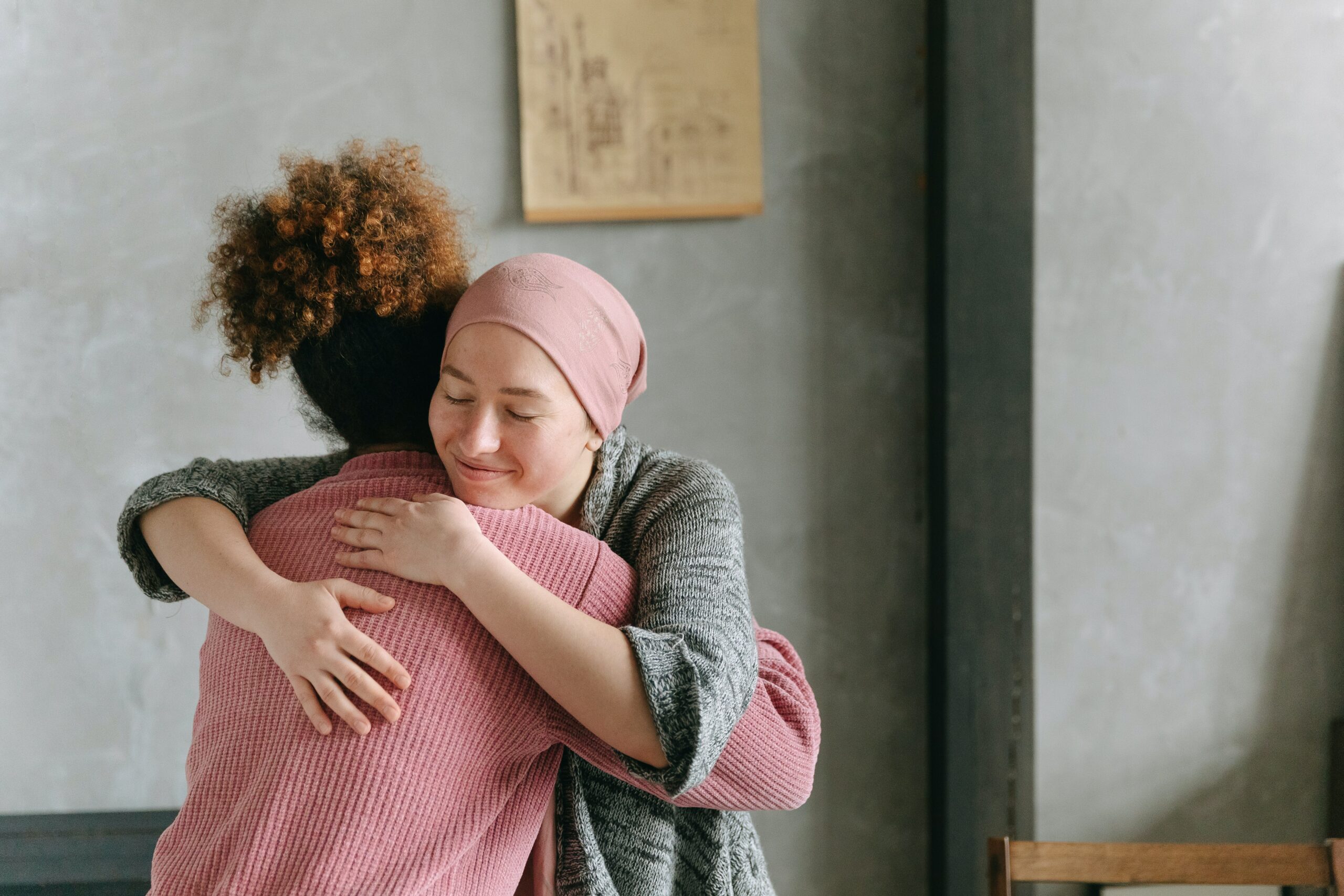 Two women hugging each other.