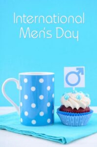 international mens day written in white on a sky blue background, a blue and white dott mug, a chocolate cupcake on blue wrap and white cream on top