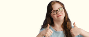 UK Disability History Month - a woman with downs syndrome giving the onlooker a thumbs up