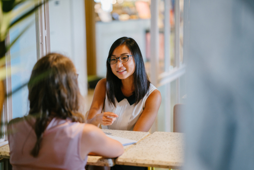 East Asian feminine person in an interview