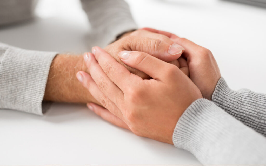 An image of two people holding hands