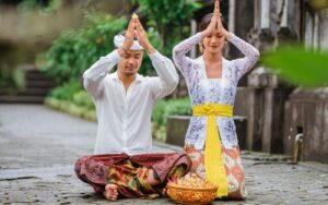 Two people praying in a temple.