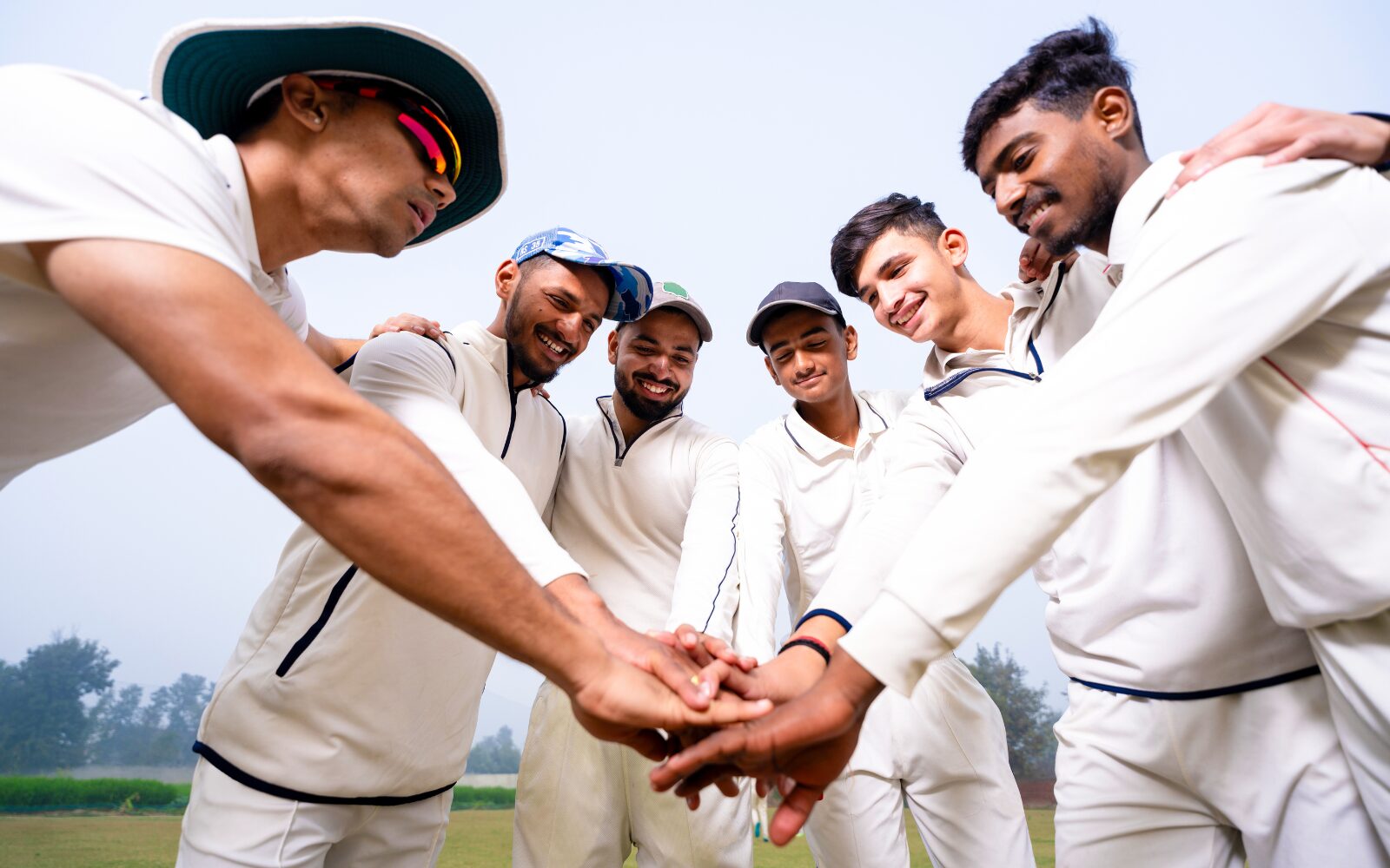 A cricket team taking part in a team huddle