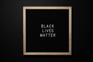 Slogan Black Lives Matter on black board.