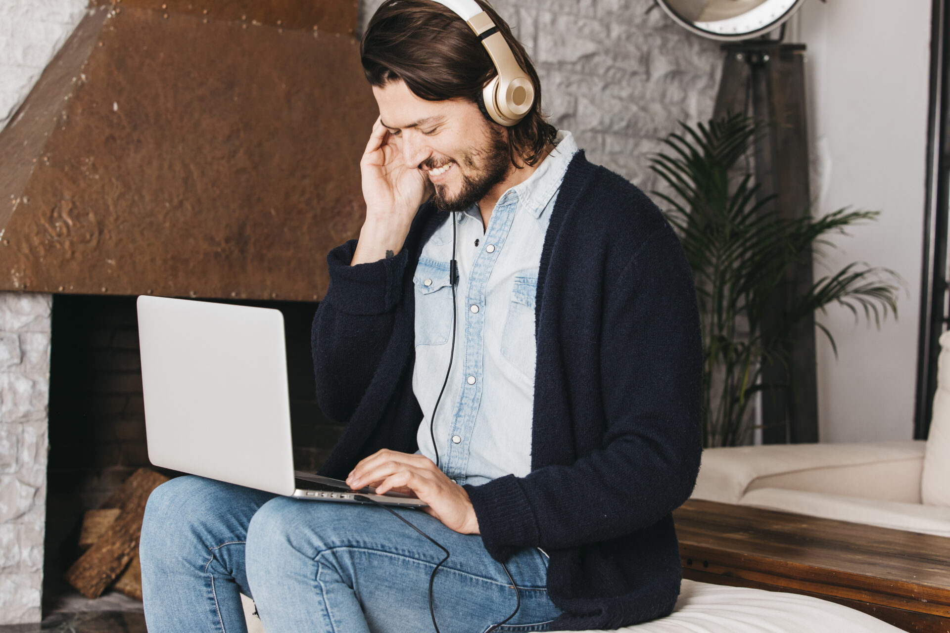smiling man with headphones and laptop