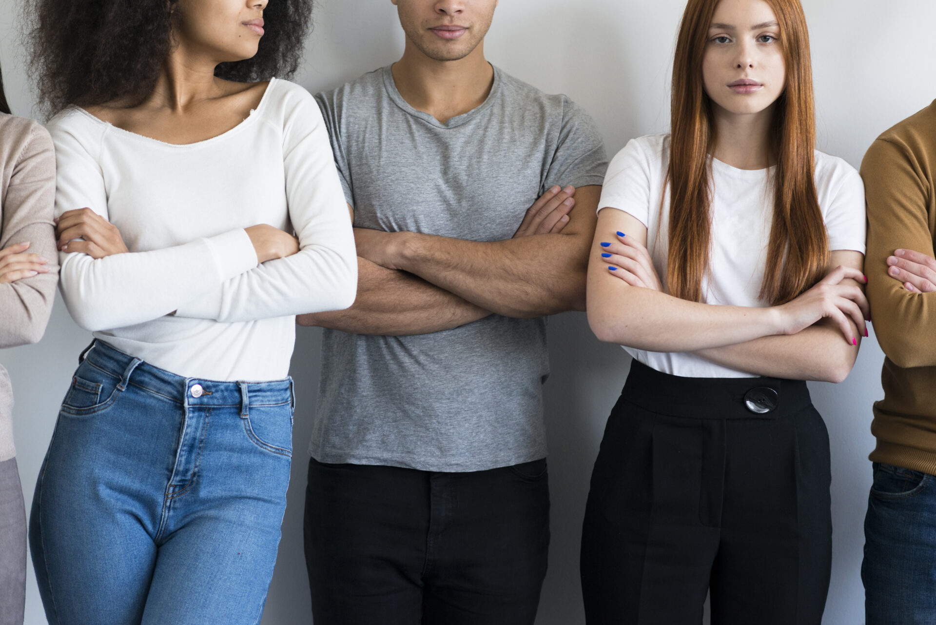 Group of people lined up with arms crossed